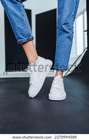 Similar – Image, Stock Photo Black pants, sneakers, legs stand with shadow on pavement