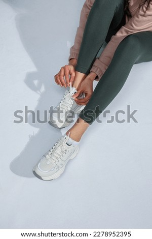 Similar – Image, Stock Photo Black pants, sneakers, legs stand with shadow on pavement