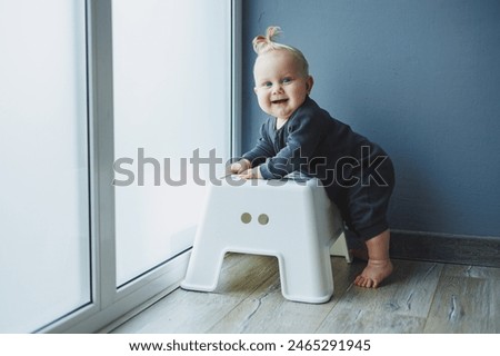 Similar – Image, Stock Photo 13 month old baby trying to navigate a ladder at a playground; reaching and pulling up to tip toes