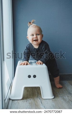 Similar – Image, Stock Photo 13 month old baby trying to navigate a ladder at a playground; reaching and pulling up to tip toes