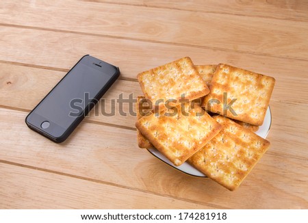 The bread and phone put on the table