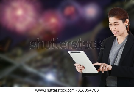 Business woman touch screen tablet on night light background - Transparent business concept.