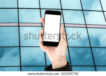 Touch screen smart phone in hand on building glass - Business co