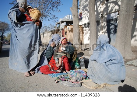 Women in burka begging