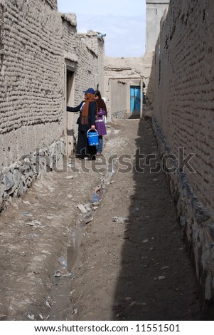 Two Afghan volunteer polio vaccinators doing their vaccination rounds