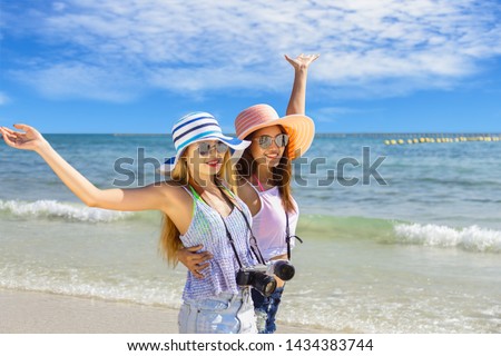 Couple girl running on the beach relaxing summer vacation.Young fashion woman relax on the beach. Happy island lifestyle.crystal. Vacation at Paradise. Ocean beach relax.
