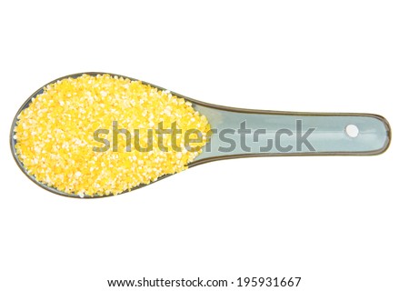 close up corn grit with china scoop isolated on white background
