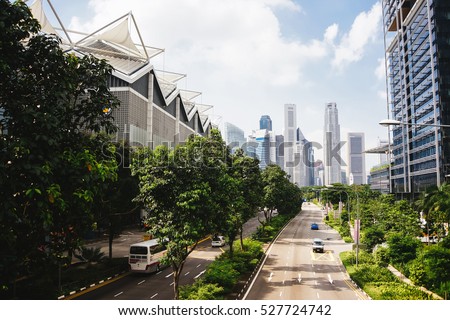 Photo of Green city of the future. City of the future. Harmony of city and nature. Sunny day in the big city. Deserted quarter, streets without people