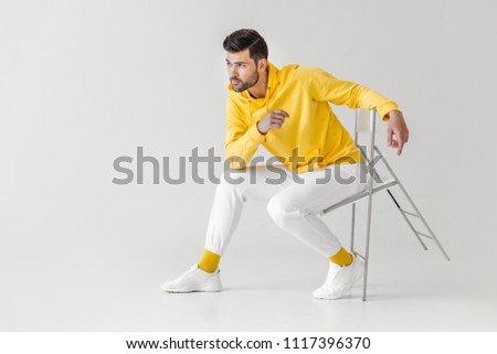 Similar – Image, Stock Photo Man sits on a white horse bridled with a bosal and looks for a carrot in his jacket pocket in thanks for the horse carrying him. In the background are blurred autumn trees.