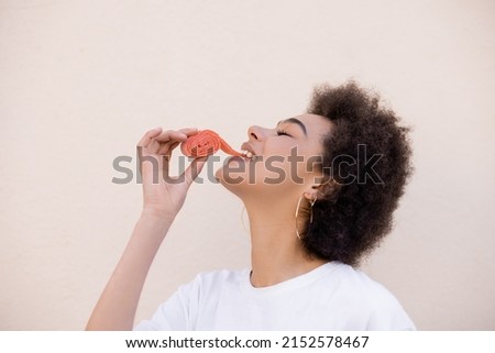 Similar – Image, Stock Photo Black woman eating candy