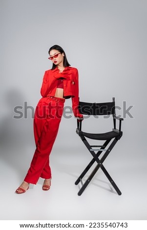 Similar – Image, Stock Photo Asian woman, posing near a tobacco drying shed, wearing a white dress and green wellies.