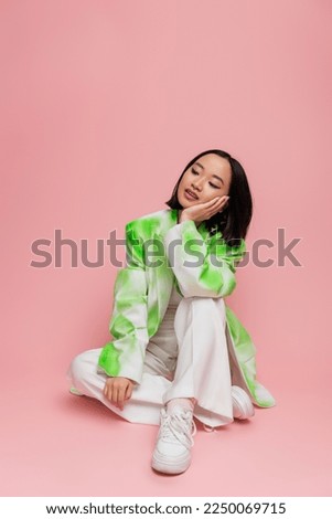 Similar – Image, Stock Photo young woman sitting with headphones on the balcony facing the backyard and planting flowers and herbs