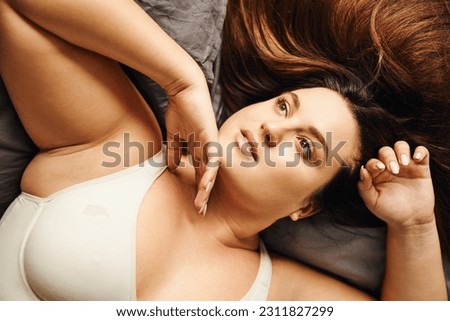 Similar – Image, Stock Photo Curvy woman in bodysuit lying on bed