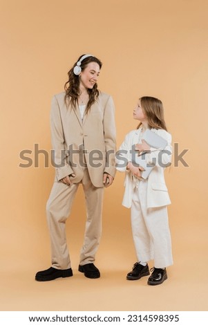 Similar – Image, Stock Photo beige wireless headphones on a purple background