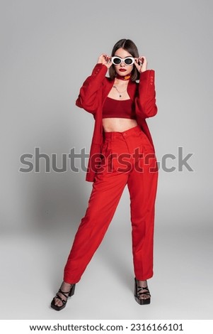 Similar – Image, Stock Photo Young woman, fashion model, posing in front of a beach booth.