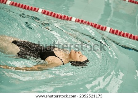 Similar – Image, Stock Photo Serene woman floating on lake water