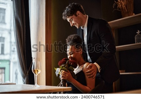 Similar – Image, Stock Photo Cheerful black woman smelling aromatic flower in hothouse