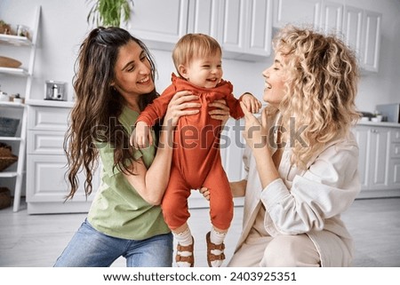 Similar – Image, Stock Photo Cheerful couple of lesbian women embracing at home