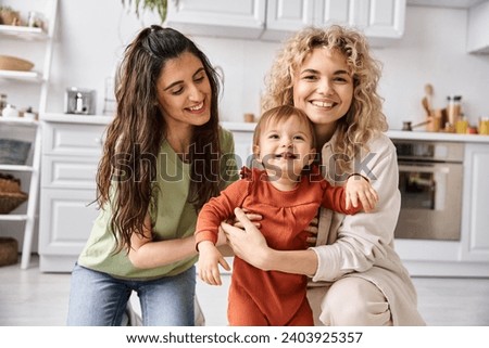 Similar – Image, Stock Photo Cheerful couple of lesbian women embracing at home