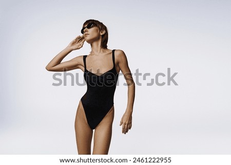 Image, Stock Photo Appealing female in swimsuit posturing on beach