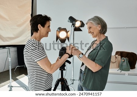 Similar – Image, Stock Photo Lesbian couple holding hands under the table and hiding their love