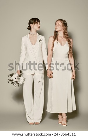 Similar – Image, Stock Photo Couple on their wedding apparel walking by the street