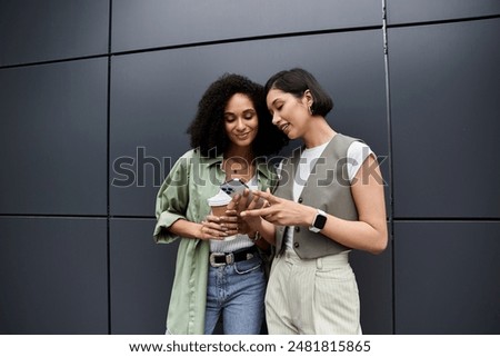 Similar – Image, Stock Photo Delighted black lesbian couple taking selfie on smartphone