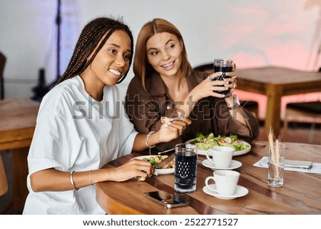 Similar – Image, Stock Photo Delighted black lesbian couple taking selfie on smartphone