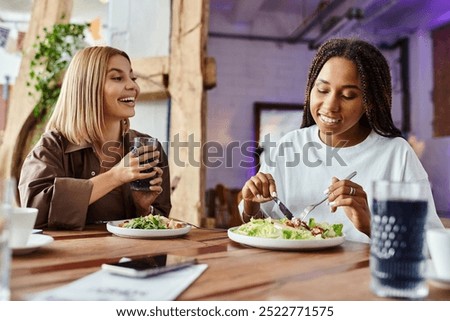 Similar – Image, Stock Photo Delighted black lesbian couple taking selfie on smartphone