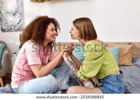 Similar – Image, Stock Photo Lesbian couple holding hands under the table and hiding their love