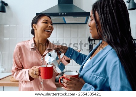 Similar – Image, Stock Photo Delighted black lesbian couple taking selfie on smartphone