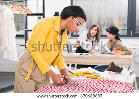 Similar – Foto Bild Schneiderin schneidet Tuch auf dem Tisch