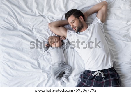 Similar – Image, Stock Photo Adorable little baby boy in feeding chair being spoon fed by his mother