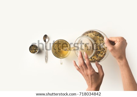 Similar – Image, Stock Photo Crop person pouring tea into bowl with herbs