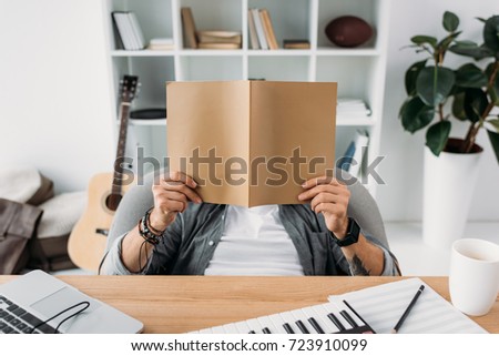 musician reading magazine with blank cover at workplace Zdjęcia stock © 