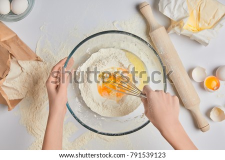 Similar – Image, Stock Photo Faceless woman preparing eggs with whisk in kitchen