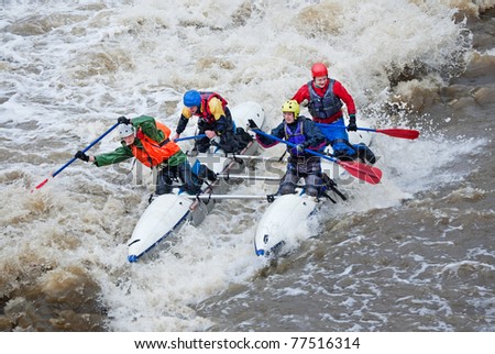 MOSCOW - APR 10: Unidentified sportsmen train in whitewater rafting techniques in Pakhra river during a traditional spring meeting \