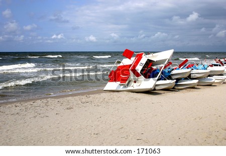 Summer on the beach, cold day, water bicycles are waiting for a warmer day..