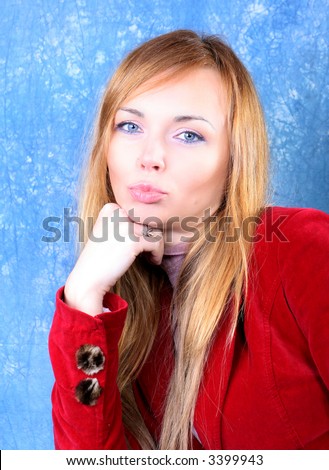 Kissing young woman portrait, in red. Studio shot
