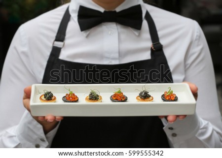 waiter with canapes / canapes with caviar / catering Photo stock © 