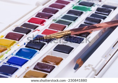 Artists watercolour paints  with brushes and pencil background hobbies and leisure time