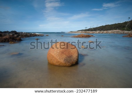 round rock sitting on the beach,tasmania