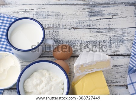 Dairy products with eggs on wooden background