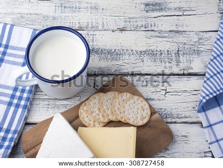 Dairy products with eggs, milk, ricotta cheese on wooden background