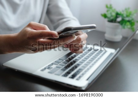 Blurred of hand of woman is touch, slide, press on screen of smart phone for check e-mail, preparation of presentation in meeting, get information for shopping online or operation of internet banking ストックフォト © 