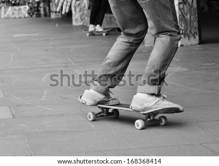 Young teen friends on skateboard in graffiti skate park