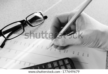 Bank statement with pencil glasses hand and calculator