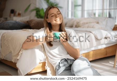 Similar – Image, Stock Photo Tranquil woman relaxing in room with glowing lamp