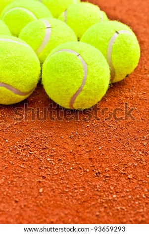 Close-up of tennis balls on a clay court