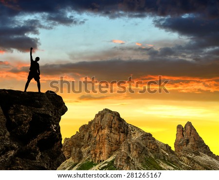Silhouette tourists on a rock in the Sexten Dolomites , Italy